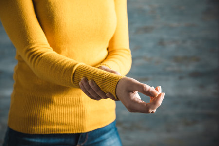 woman hand in ache hand on abstract backgroundの写真素材