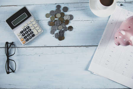 coins and piggy bank with calculator on the table