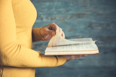 woman reading book on blue abstract background