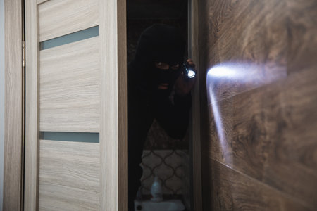 the dangerous burglar sneaking into the houseの写真素材