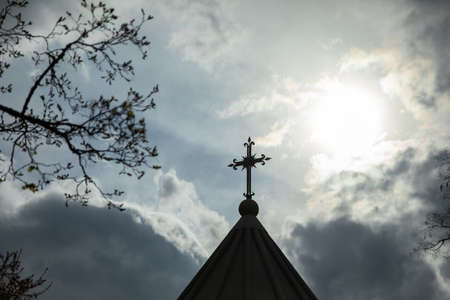 church cross under abstract dark sky background