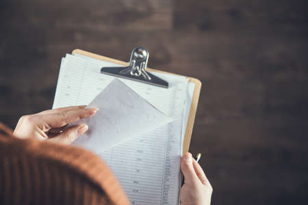 woman hand holding document on the dark background