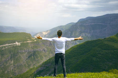 happy man in the green mountain backgroundの写真素材