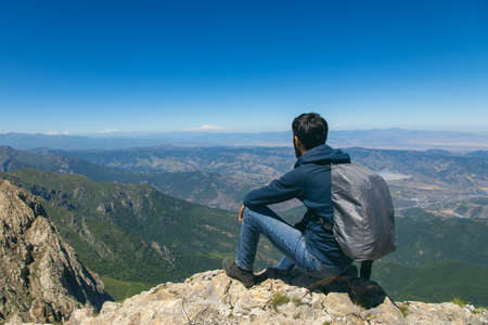 traveling young man in the mountain backgroundの写真素材