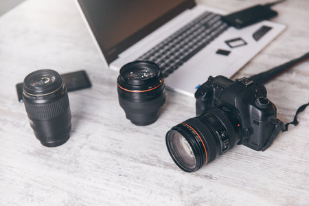 camera with lenses and computer on table