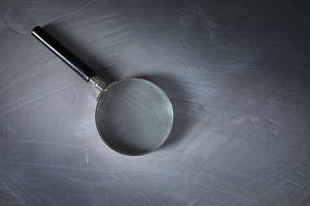 magnifier on the abstract gray table background