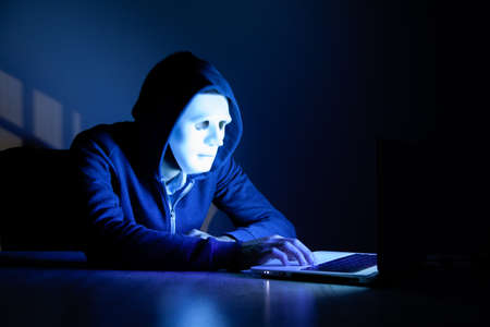 hacker man and computer in the dark roomの写真素材