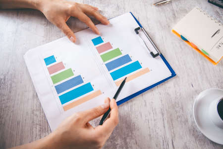 man hand pen on graph in office deskの写真素材