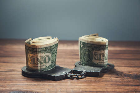money on the handcuffes on the table background