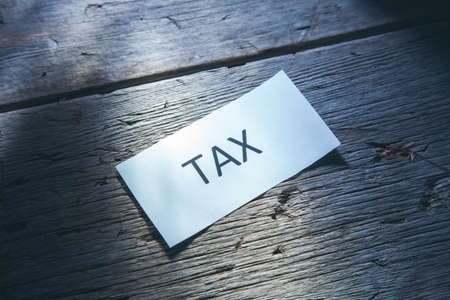 tax text on paper on wooden table