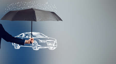 man hand umbrella and car in the screenの写真素材