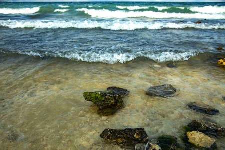 rocky lake beach with dark abstract sky