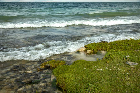 rocky lake beach with dark abstract skyの写真素材