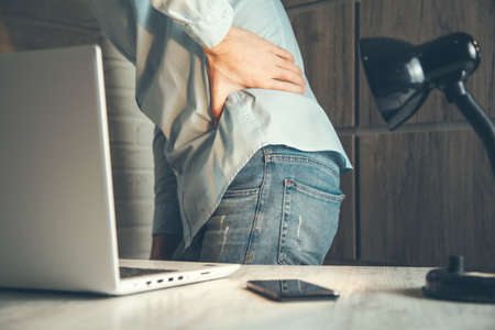 man hand in ache back in office backgroundの写真素材