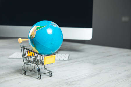 globe on the basket and computer on the desk
