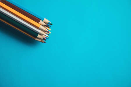 colorful pencils on the blue table backgroundの写真素材