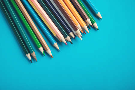 colorful pencils on the blue table backgroundの写真素材