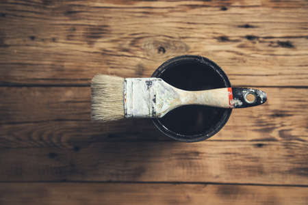 brush on the paint bowl on the wooden tableの写真素材