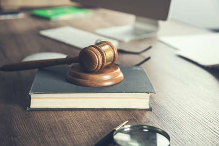Judge gavel and book on wooden office deskの写真素材