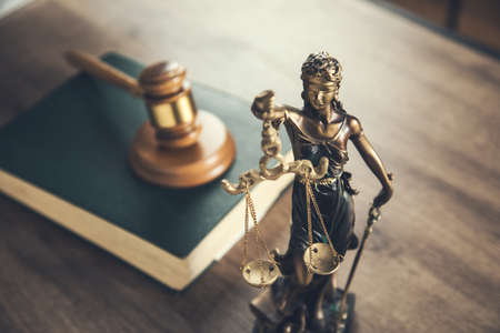 wooden judge on book with justice lady on deskの写真素材