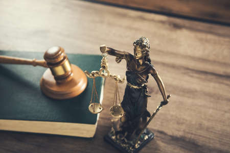 wooden judge on book with justice lady on deskの写真素材