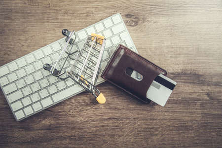 card and basket on the white keyboardの写真素材