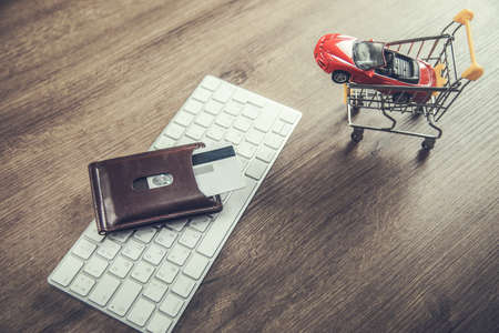 shopping car with card and basket on laptopの写真素材