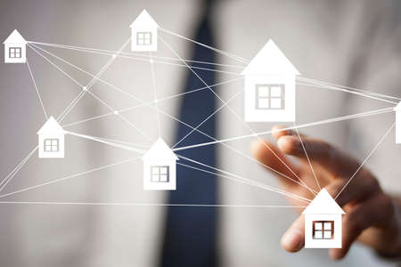 man touching house network in the screenの写真素材