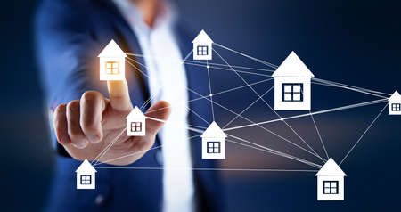 man touching house network in the screenの写真素材