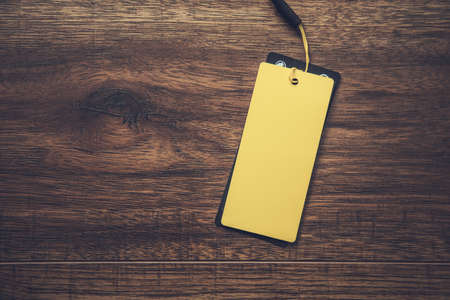 yellow paper label on the wooden background