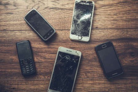 old mobile phones on a table backgroundの写真素材