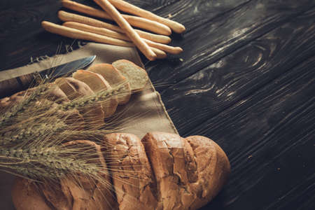 bread and wheat on the table backgroundの写真素材