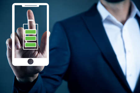 man touching battery with full of energyの写真素材