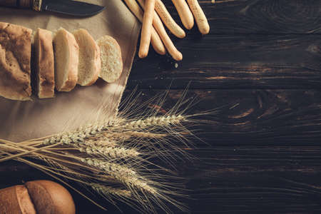 bread and wheat on the table backgroundの写真素材