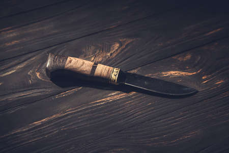 small knife on the wooden table background