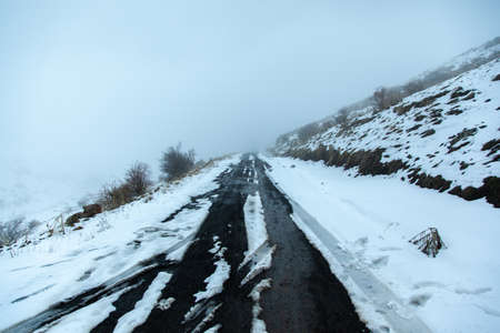 mountain road in snowy winter dayの写真素材