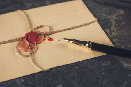 vintage letters and pen on a tableの写真素材