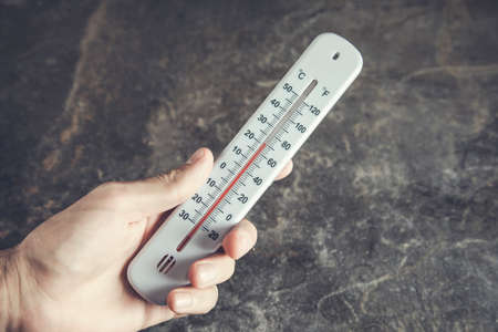 man hand holding a thermometer for airの写真素材