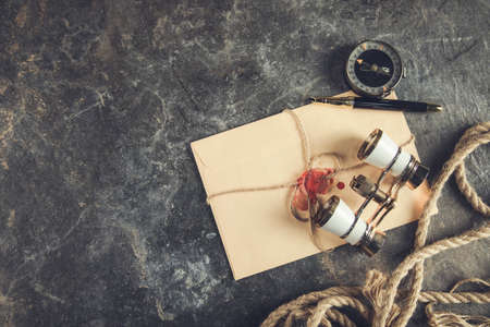 vintage letters with compass and binoculars on table
