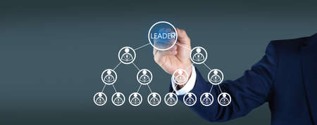 Businessman writes in screen. Concept of Leader