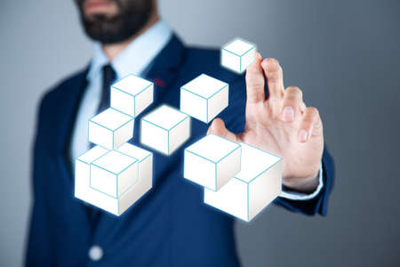 Man touching cube symbols in screenの写真素材