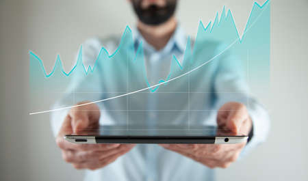 businessman plan graph growth in tablet screen