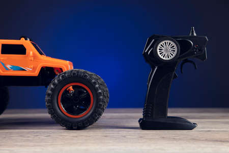 remote control and toy car on blue backgroundの写真素材