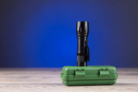 small lantern on green box on dark background