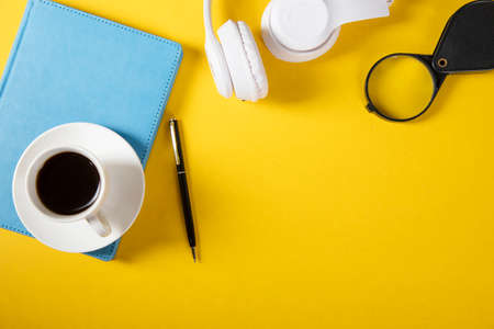 coffee on notebook with earphone on table