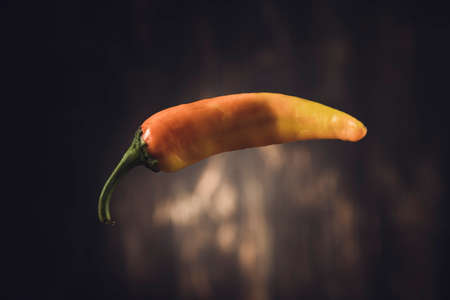 yellow hot pepper on wooden backgroundの写真素材