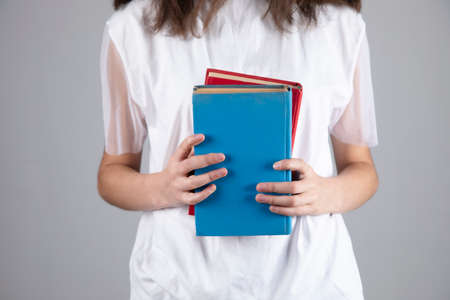 young woman holding booksの写真素材