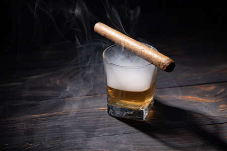 glass of whiskey and cigar.