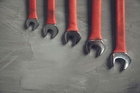 wrenches of different sizes on abstract background