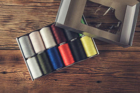 colored thread coils on box on the tableの写真素材